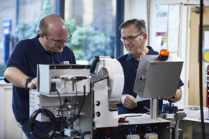 engineers working on a We Seal bag sealing machine