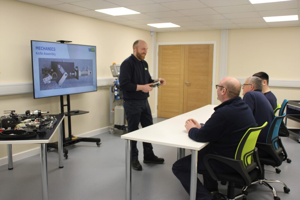 An engineer demonstrating mechanics of automatic bag sealing machine from we seal